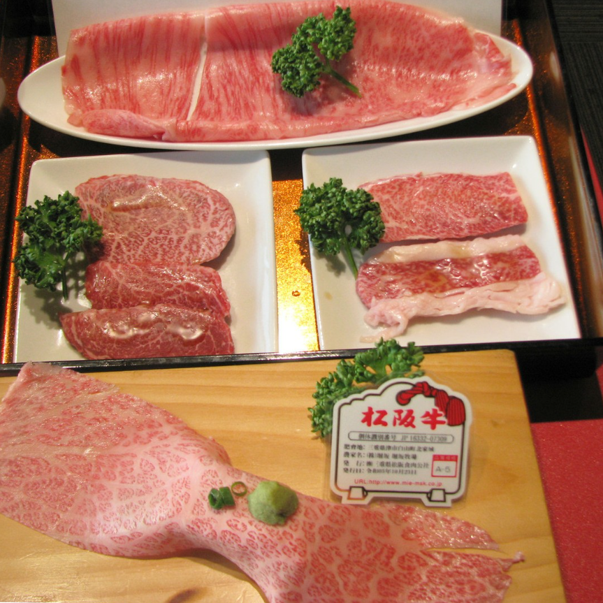 A calm interior view of a yakiniku restaurant with wood-grain tables and rounded chairs lined up, with soft natural light falling on the seats